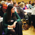 A woman sat down in the audience of a conference listening intently