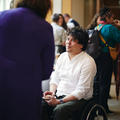 A man in a wheelchair talking to a fellow conference attendee