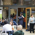 An outdoor space at Pembroke College, Oxford filled with conference attendees networking