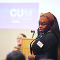 A woman giving a talk at a conference