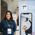 a startup founder smiling at their stand