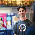 An exhibitor talking to event attendees at their stand