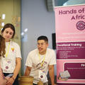 A starup founder talking to an event attendee at their stand