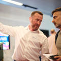 event attendees talking to an exhibitor at their stand