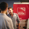 Two people talking at an exhibition stand