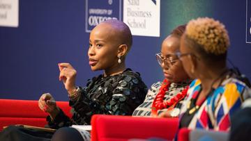 Three women taking part in a panel discussion at Oxford Business Forum Africa